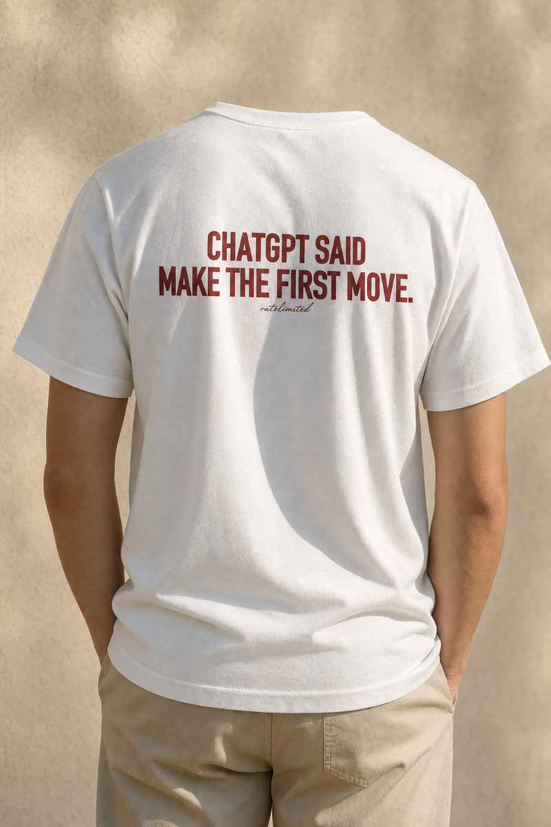 Model seen from behind wearing the white First Move tee, back print reading "ChatGPT said make the first move"