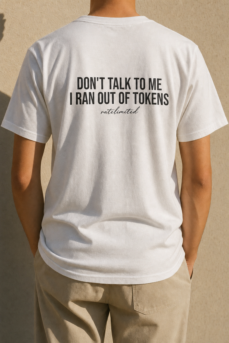 Model seen from behind wearing the white Out Of Tokens tee, back print reading "Don't talk to me, I ran out of tokens"